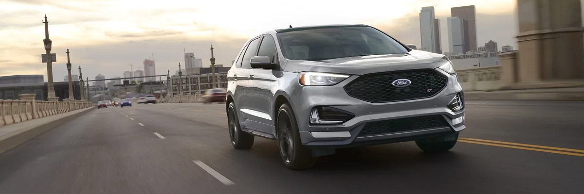 2022 Ford Edge being driven down a road with a city in the background