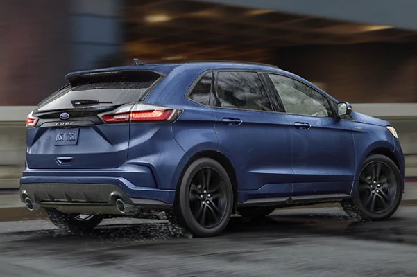 2022 Ford Edge in Atlas Blue being driven down a road