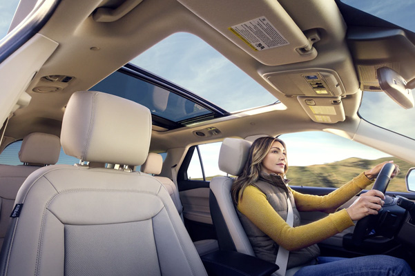 2022 Ford Explorer being driven by a woman with the available twin-panel moonroof halfway open