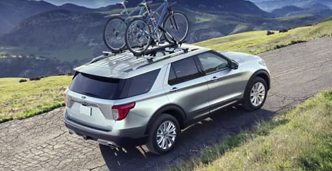 2022 Ford Explorer in Iconic Silver being driven up a paved mountain road