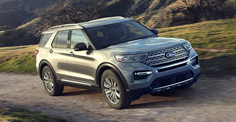 2022 Ford Explorer Limited in Iconic Silver being driven up a steep road with hills in the background