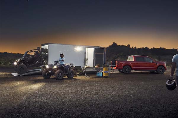 A trailer hauling off road vehicles being lit up by the 2021 Ford F 1 50 zone lighting