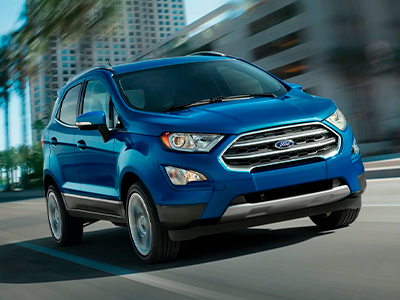 2022 Ford EcoSport® in Lightning Blue Metallic being driven in large city near palm trees