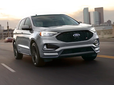 2022 Ford Edge being driven down a road with a city in the background