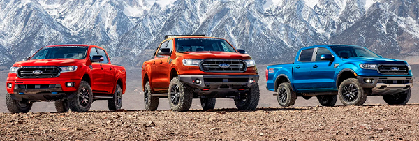 Various 2022 Ford Ranger models with Ford Performance Packages parked on dirt in front of mountain landscape