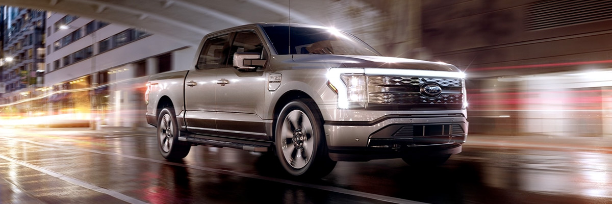 A 2022 Ford® F-150 Lightning driving through a tunnel in an urban environment