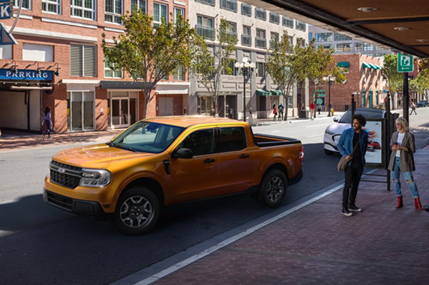 Ford Maverick parked on the side of a city street in the day