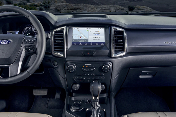 2022 Ford Ranger LARIAT interior with leather-wrapped steering wheel and 8-inch center stack touchscreen.