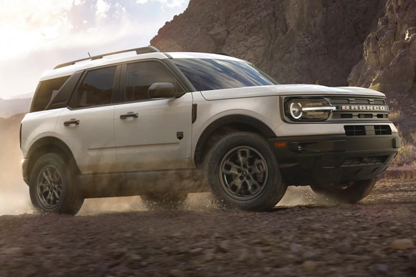2022 Ford Bronco Sport driving off road with a mountain in the background.