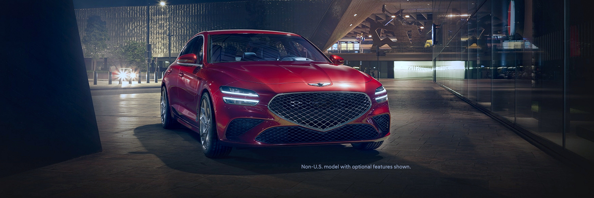 2022 Genesis G70 1/3 front view while the car is parked. Placed in a dark city background