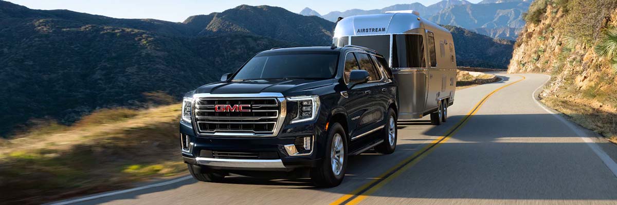 2022 GMC Yukon SLE SLT Full size SUV Cruising down Road