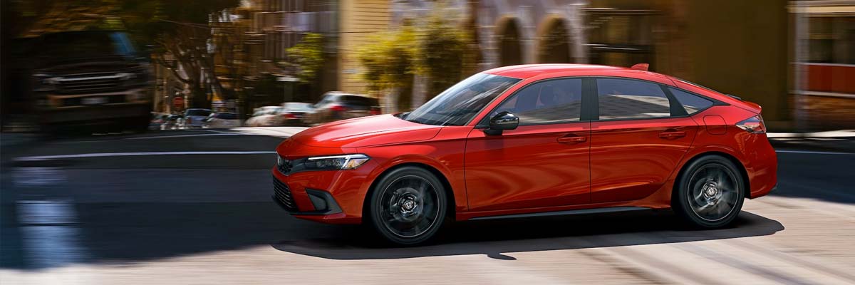 Sport shown in Rallye Red driving on a city street