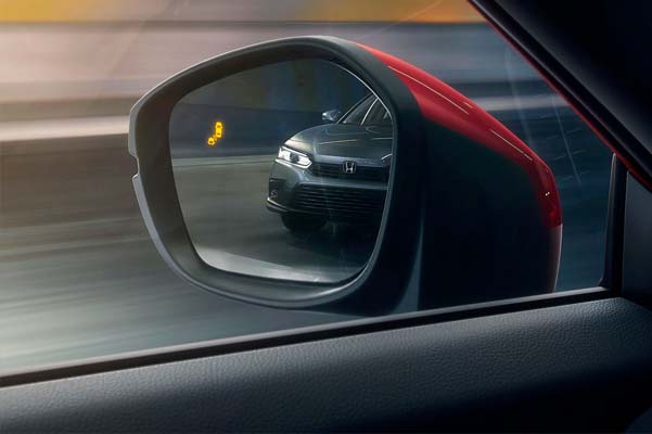 Detail view of driver-side mirror with blind spot information indicator in the 2022 Honda Civic Sport Touring Hatchback.