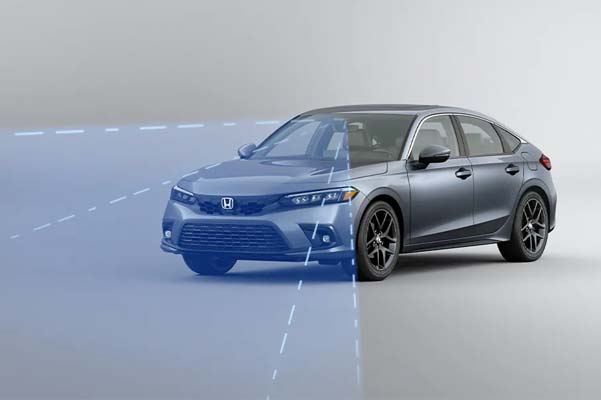 Front driver-side view of the 2022 Honda Civic Sport Touring Hatchback in Sonic Gray Pearl with illustrated lines demonstrating Honda Sensing® feature.