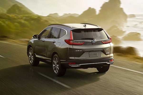 rear shot of a 2022 Honda CR-V Hybrid driving along coast