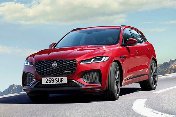 Front view of red 2022 Jaguar F-PACE driving on the road