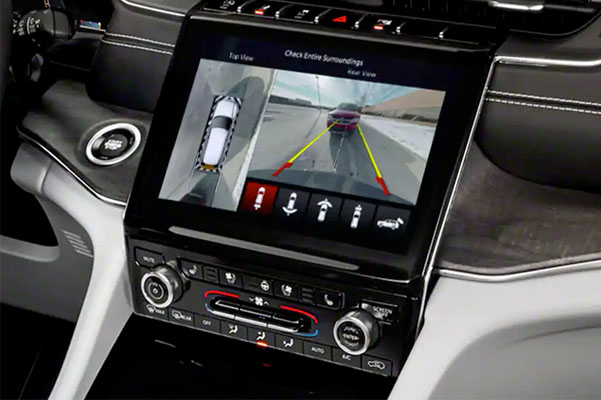 The touchscreen in the 2022 Grand Cherokee displaying a split screen of the top view and rear view surround view camera angles.