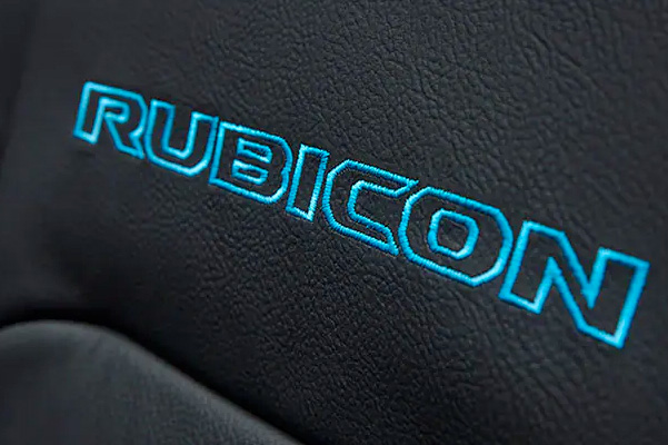 A close-up of the front seat with the word Rubicon embroidered in blue on the 2022 Jeep Wrangler Rubicon 4xe.
