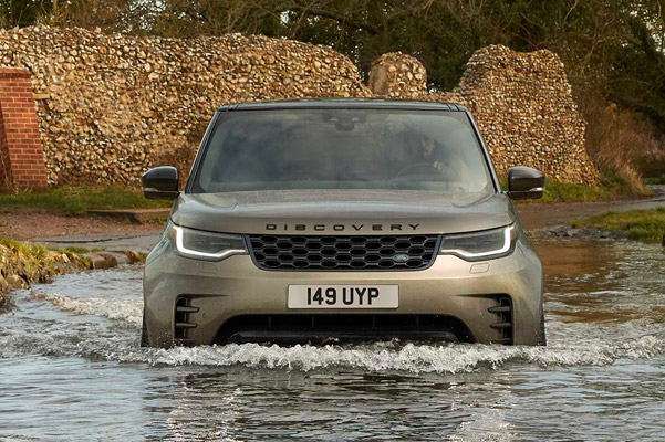 Exterior shot of a 2022 LAND ROVER DISCOVERY driving in a body of water