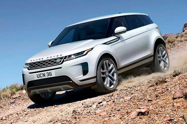 2022 Range Rover Evoque driving down side of cliff kicking up dust.