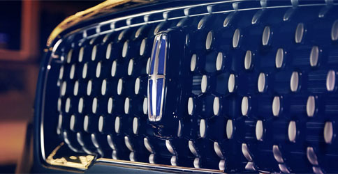 The Grand Touring grille design shows floating chrome ovals that catch the light and frame the distinctive Lincoln Star