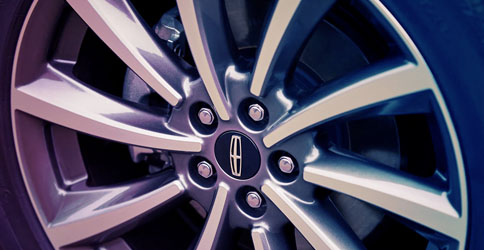 A close-up of 2022 Lincoln Corsair twenty inch bright machined aluminum wheel with dark tarnished finish