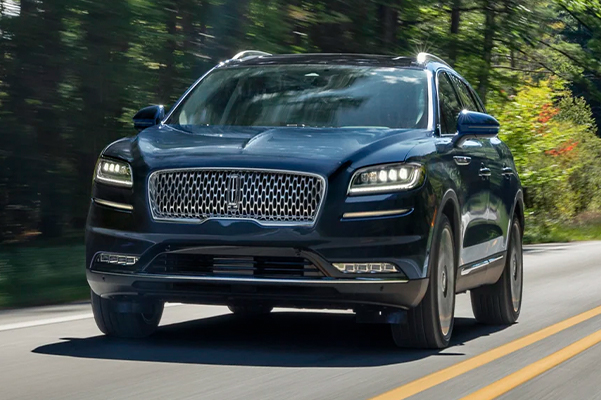 A 2022 Lincoln Black Label Nautilus is being driven along a country road