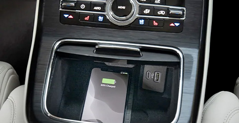 A smart phone is charging on the wireless charger in the 2022 Lincoln Nautilus