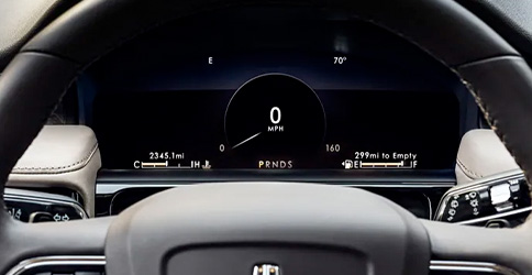 The 12.3-inch driver display screen behind the steering wheel in a 2022 Lincoln Nautilus shows trip information