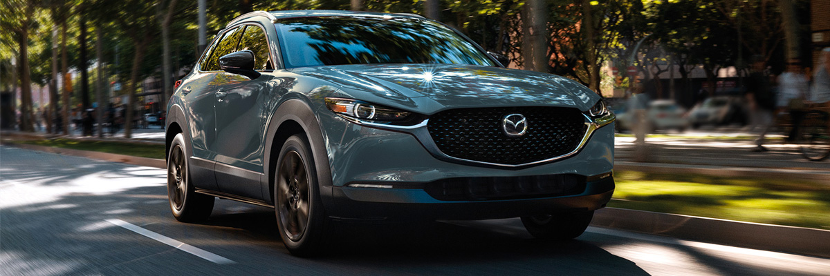2022 Mazda CX-30 drivign down city street during the day