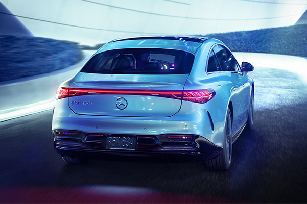 Rear shot of a 2022 Mercedes-Benz EQS driving in a tunnel.