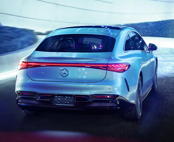 Mercedes-Benz EQS rear view driving on the road