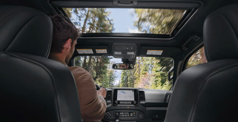 Interior of the 2022 Nissan Frontier showing the touchscreen and glass moonroof