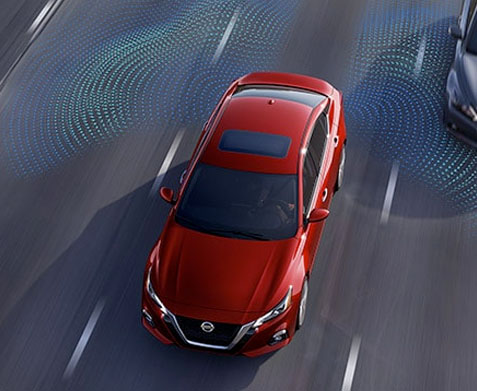 2022 Nissan Altima on highway showing blind spot warning technology.