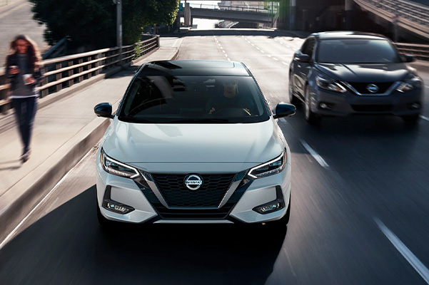 2022 Nissan Sentra front view driving to illustrate low wide stance.