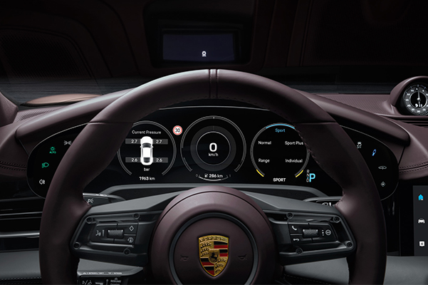 Detail shot of a 2022 Porsche Taycan steering wheel.