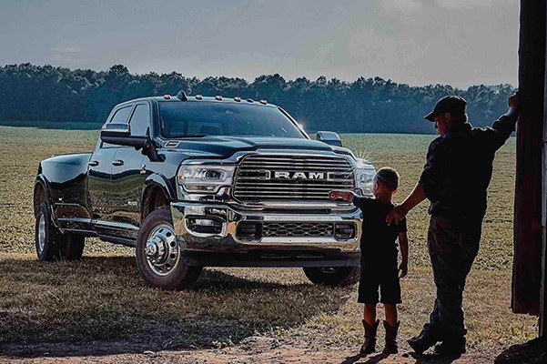Father and son looking at a 2022 RAM 3500