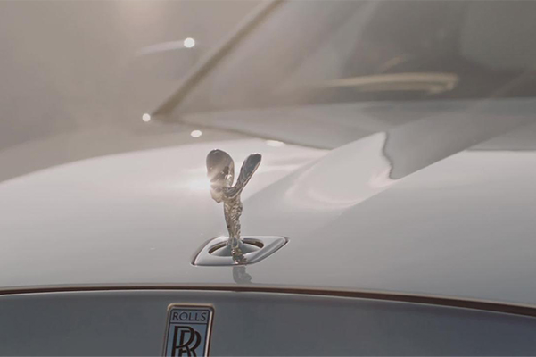 Detail shot of a New Rolls-Royce Ghost hood emblem.