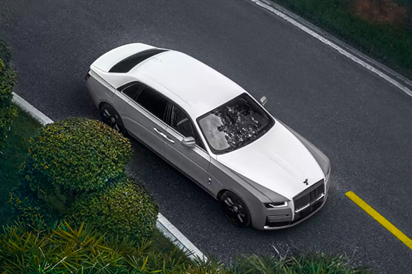 Above shot of a New Rolls-Royce Ghost driving down a road.
