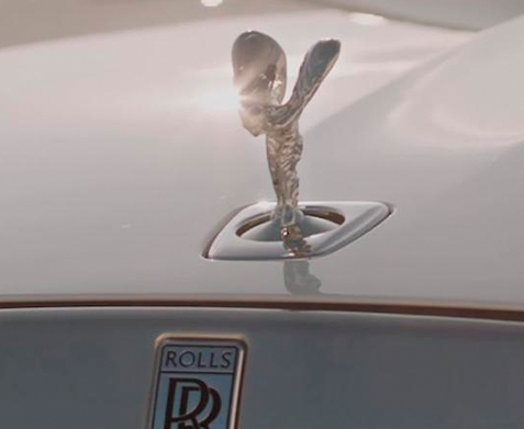 The Spirit of Ecstasy iconic figure on front hood of a Rolls-Royce Ghost motor car.