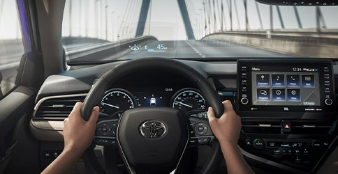 XLE interior shown in Macadamia leather trim with available Premium Audio with JBL® and Driver Assist Package. Prototype vehicle shown with options using visual effects.