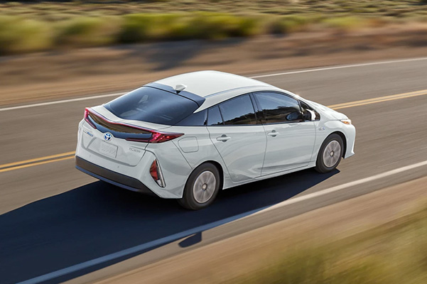 performance shot of a white 2022 Toyota Prius Prime on the highway
