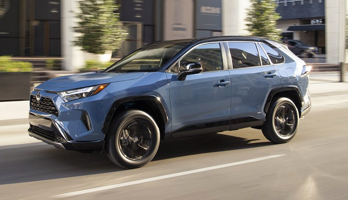 Blue 2022 Toyota RAV4 Hybrid driving on the road