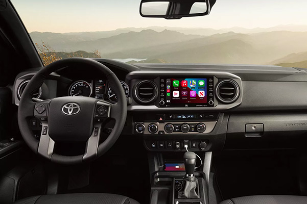 TRD Off-Road interior shown in Black leather trim with available TRD Off-Road Premium Package and Advanced Technology Package. Apple CarPlay® screen shown. Prototype shown with options.