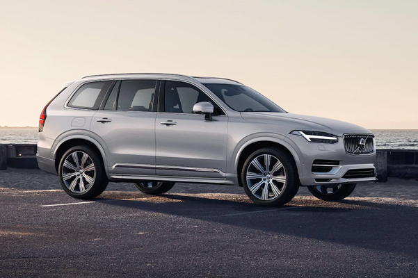 2022 Volvo XC90 Recharge parket with the ocean in the background at sunset.