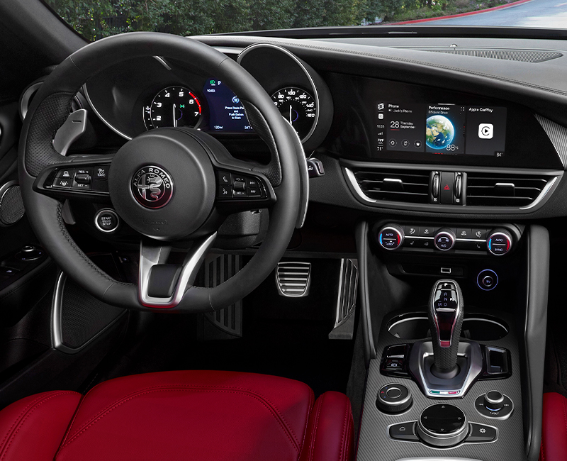 2023 Alfa Romeo Giulia interior, showing the steering wheel, center stack controls and dash.