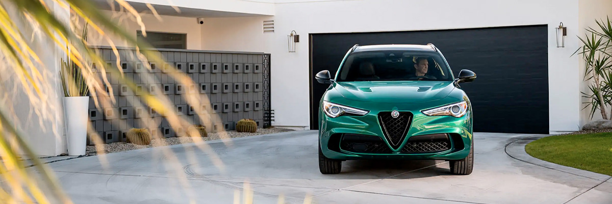 The 2023 Alfa Romeo Stelvio from the front, parked in a driveway