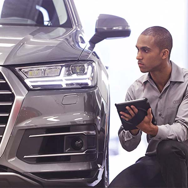 Audi technician checking the headlights on an Audi car