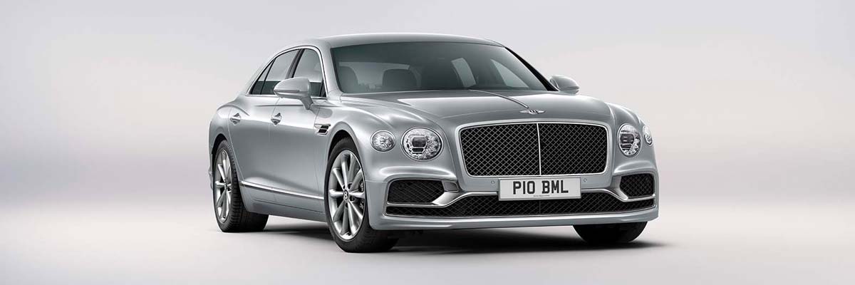 Exterior shot of a 2023 Bentley Flying Spur Hybrid parked in a white studio.