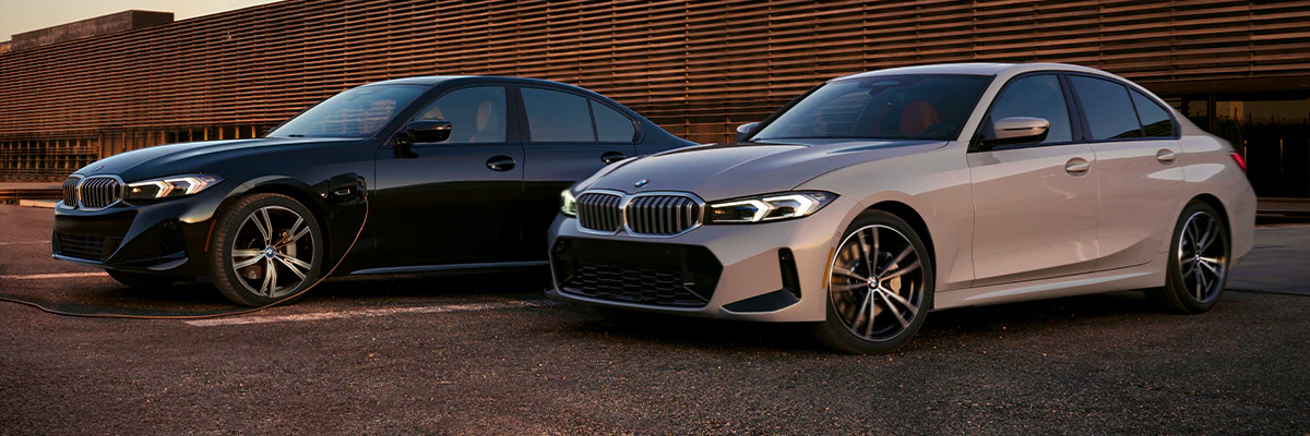 Two 2023 BMW 3 Series vehicles parked next to each other.